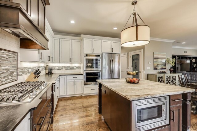 212 S Wa Pella Ave, Mount Prospect, IL 60056 - kitchen featuring appliances with stainless steel finishes, ornamental molding, decorative backsplash, recessed lighting, and white cabinets