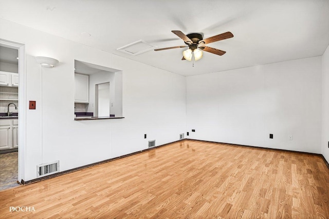 9446 Magnolia Ave, Mokena, IL 60448 - unfurnished room with light wood-style flooring, ceiling fan, and attic access
