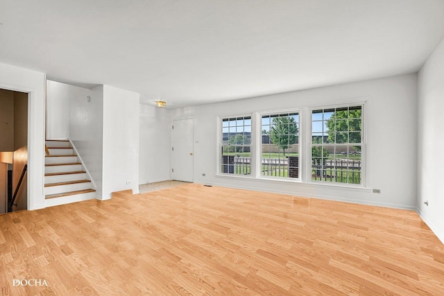 9446 Magnolia Ave, Mokena, IL 60448 - unfurnished living room featuring wood finished floors and stairway