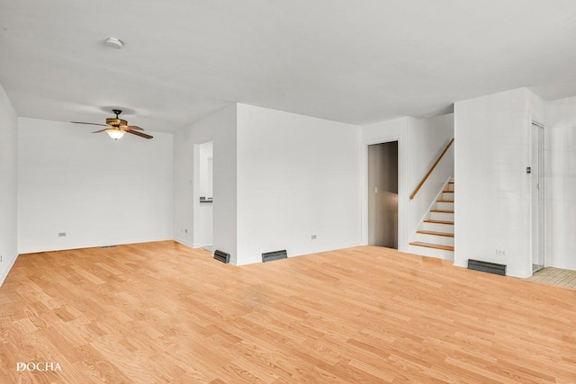 9446 Magnolia Ave, Mokena, IL 60448 - unfurnished living room featuring wood finished floors, stairway, and ceiling fan