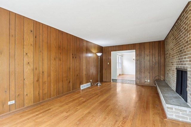 1139 W Illinois Ave, Palatine, IL 60067 - unfurnished living room featuring a fireplace, wood finished floors, and wooden walls