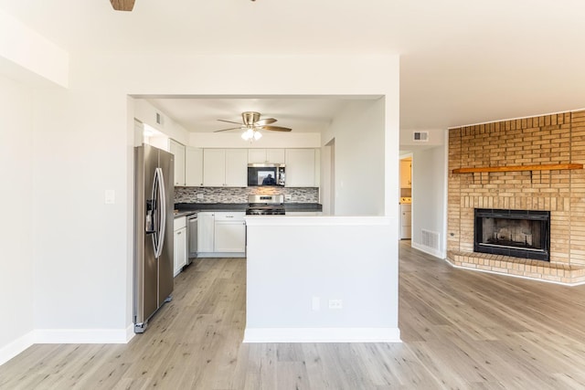 6154 W 63rd St Unit 3W, Chicago, IL 60638 - kitchen featuring stainless steel appliances, open floor plan, white cabinets, ceiling fan, and light wood finished floors