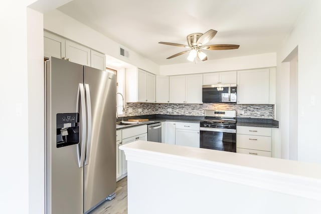 6154 W 63rd St Unit 3W, Chicago, IL 60638 - kitchen with stainless steel appliances, tasteful backsplash, a sink, ceiling fan, and dark countertops