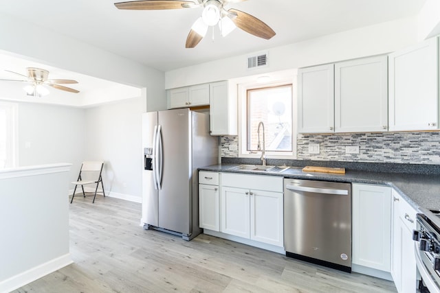 6154 W 63rd St Unit 3W, Chicago, IL 60638 - kitchen featuring appliances with stainless steel finishes, a sink, ceiling fan, tasteful backsplash, and light wood-style flooring