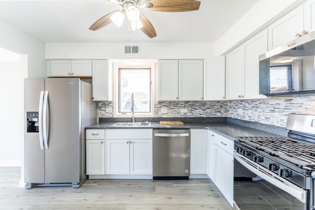 6154 W 63rd St Unit 3W, Chicago, IL 60638 - kitchen featuring stainless steel appliances, dark countertops, tasteful backsplash, and white cabinets