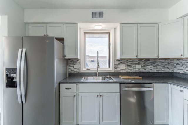 6154 W 63rd St Unit 3W, Chicago, IL 60638 - kitchen with appliances with stainless steel finishes, a sink, dark countertops, and decorative backsplash