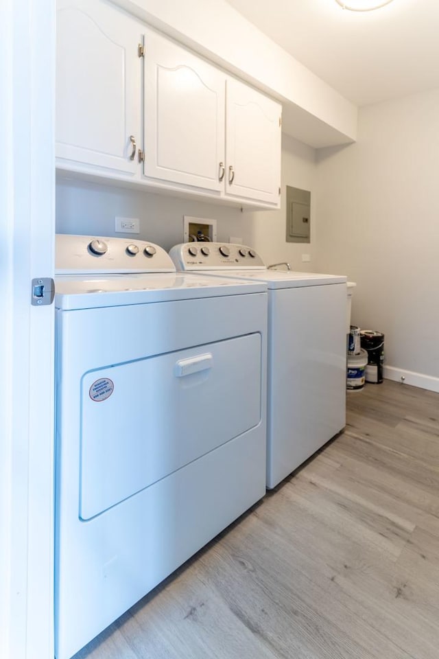 6154 W 63rd St Unit 3W, Chicago, IL 60638 - washroom featuring washing machine and clothes dryer, cabinet space, light wood-style flooring, electric panel, and baseboards