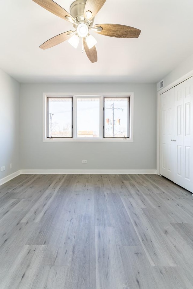6154 W 63rd St Unit 3W, Chicago, IL 60638 - unfurnished bedroom with multiple windows, light wood finished floors, and baseboards