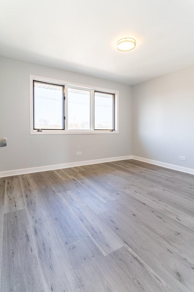 6154 W 63rd St Unit 3W, Chicago, IL 60638 - spare room featuring wood finished floors and baseboards