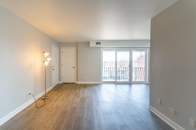 6154 W 63rd St Unit 3W, Chicago, IL 60638 - unfurnished living room with wood finished floors and baseboards