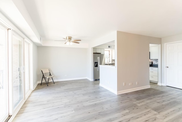 6154 W 63rd St Unit 3W, Chicago, IL 60638 - unfurnished living room featuring a ceiling fan, light wood finished floors, and baseboards