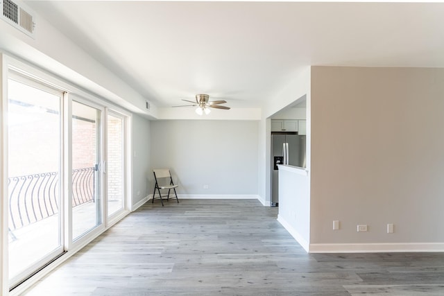6154 W 63rd St Unit 3W, Chicago, IL 60638 - empty room featuring a ceiling fan, light wood-type flooring, and baseboards