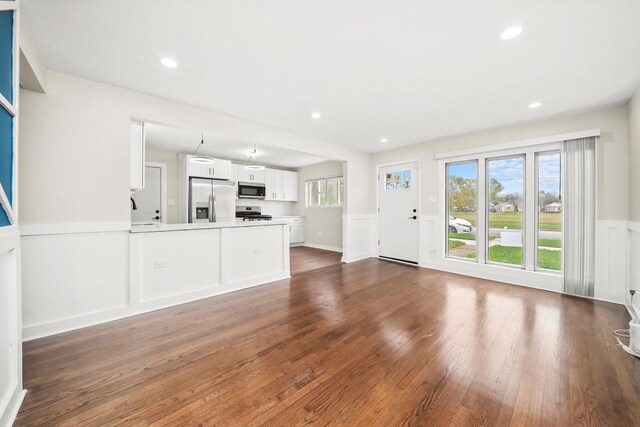 10244 S Crandon Ave, Chicago, IL 60617 - unfurnished living room with wainscoting, dark wood-style floors, a sink, and recessed lighting