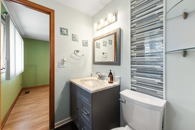 1018 Brighton Ct, Schaumburg, IL 60193 - bathroom with vanity, toilet, baseboards, and wood finished floors