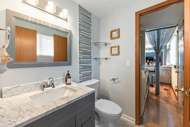 1018 Brighton Ct, Schaumburg, IL 60193 - bathroom with healthy amount of natural light, vanity, wood finished floors, and toilet