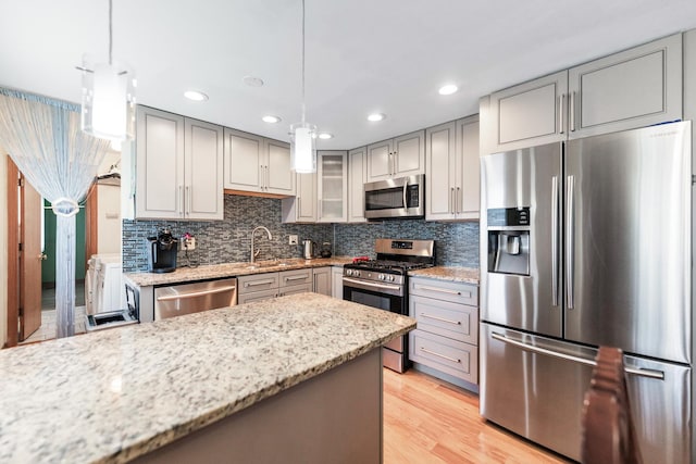 1018 Brighton Ct, Schaumburg, IL 60193 - kitchen with stainless steel appliances, gray cabinetry, a sink, tasteful backsplash, and light stone counters