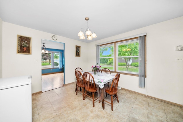 421 Carey Ct, Chicago Heights, IL 60411 - dining space featuring a chandelier and baseboards