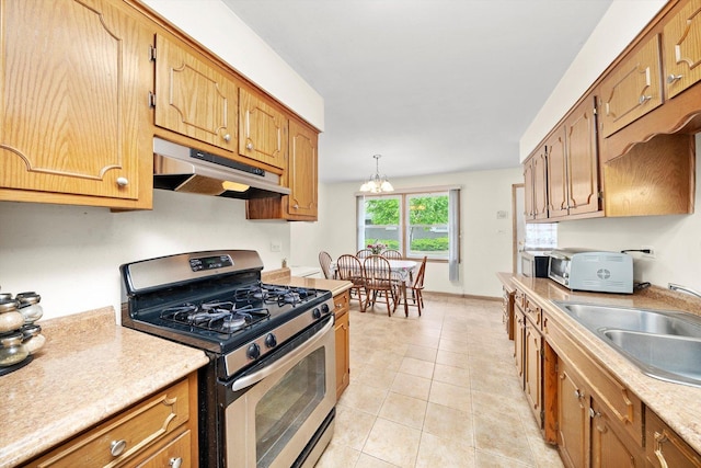 421 Carey Ct, Chicago Heights, IL 60411 - kitchen featuring stainless steel range with gas cooktop, under cabinet range hood, a sink, light countertops, and brown cabinets
