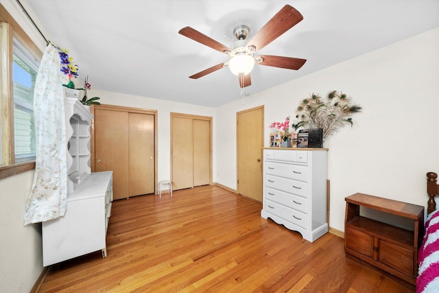 421 Carey Ct, Chicago Heights, IL 60411 - bedroom with multiple closets, light wood-type flooring, a ceiling fan, and baseboards