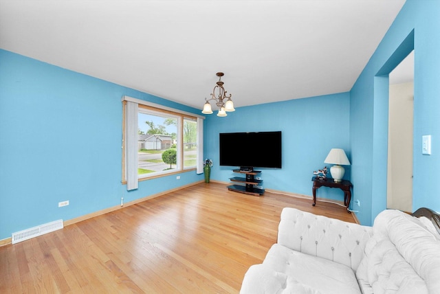 421 Carey Ct, Chicago Heights, IL 60411 - living room with a chandelier, wood finished floors, and baseboards