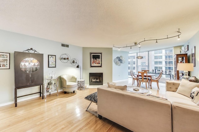 1580 Sherman Ave Unit 1006, Evanston, IL 60201 - living room with light wood-style floors, a fireplace, and baseboards
