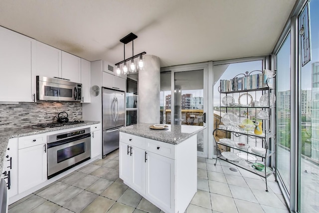 1580 Sherman Ave Unit 1006, Evanston, IL 60201 - kitchen featuring appliances with stainless steel finishes, healthy amount of natural light, tasteful backsplash, and light tile patterned floors