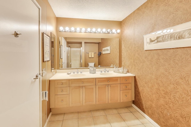 1580 Sherman Ave Unit 1006, Evanston, IL 60201 - full bathroom with wallpapered walls, double vanity, tile patterned flooring, baseboards, and a shower stall