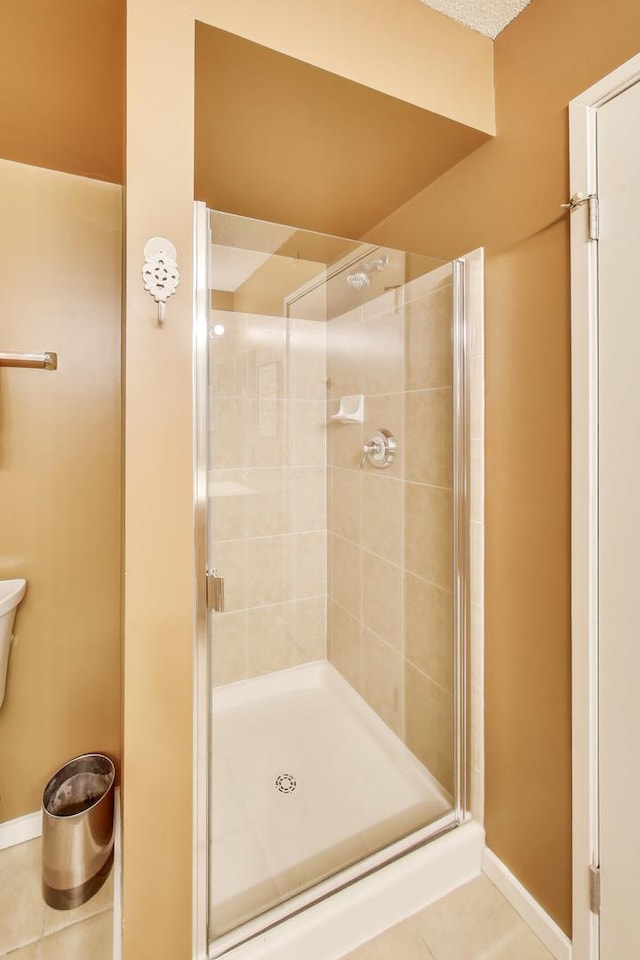 1580 Sherman Ave Unit 1006, Evanston, IL 60201 - full bathroom with a stall shower, baseboards, and tile patterned floors