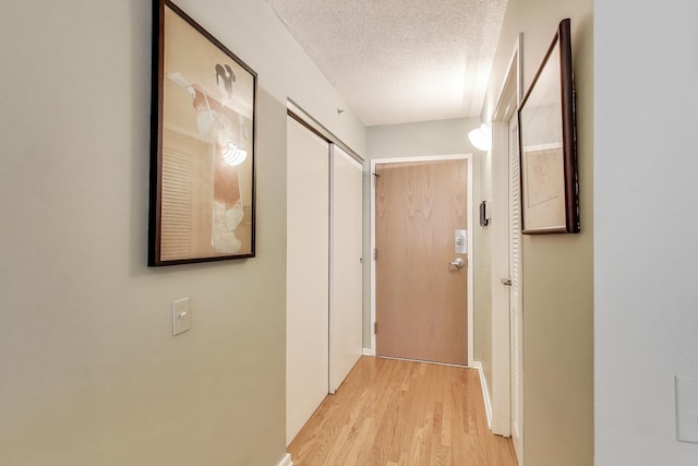 1580 Sherman Ave Unit 1006, Evanston, IL 60201 - hall featuring a textured ceiling, light wood-type flooring, and baseboards