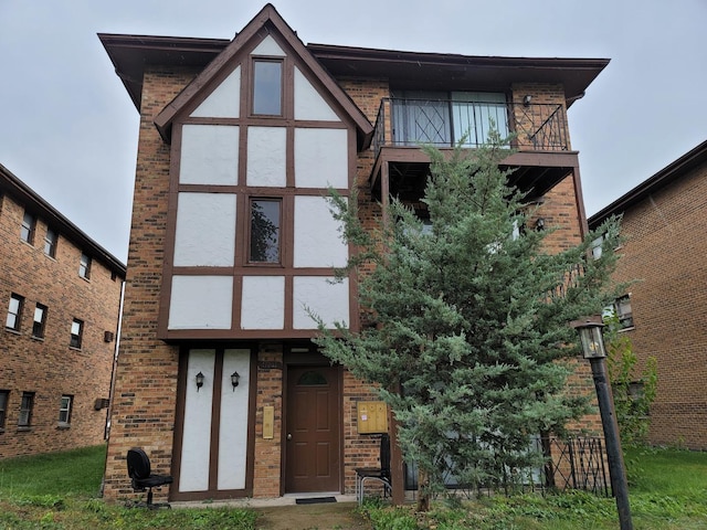 17307 Lathrop Ave, East Hazel Crest, IL 60429 - view of front facade with stucco siding, a balcony, and brick siding