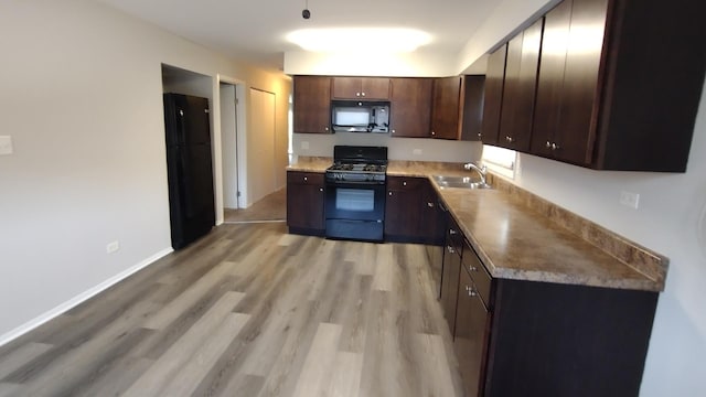 17307 Lathrop Ave, East Hazel Crest, IL 60429 - kitchen featuring black appliances, a sink, light wood-style floors, and dark brown cabinets