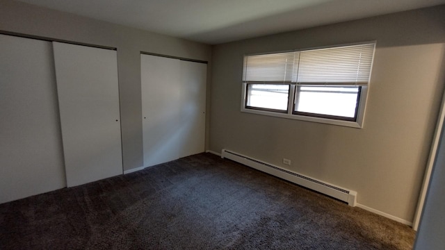 17307 Lathrop Ave, East Hazel Crest, IL 60429 - unfurnished bedroom with a baseboard radiator, dark carpet, and two closets