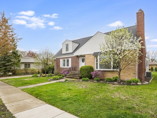 1212 S Greenwood Ave, Park Ridge, IL 60068 - view of front of home with a front lawn, brick siding, a chimney, and stone siding