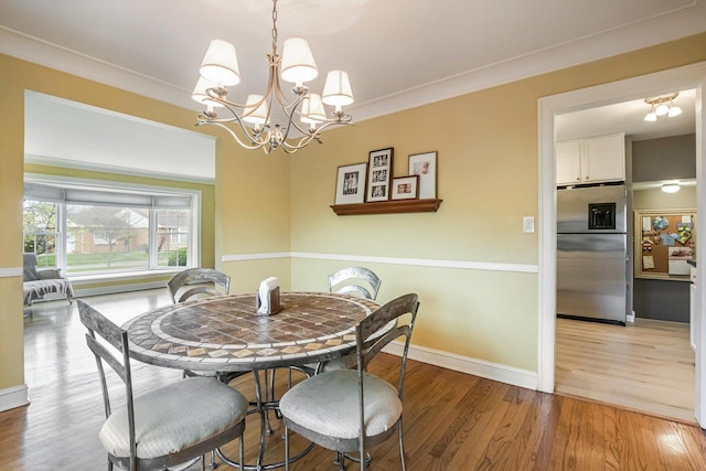 1212 S Greenwood Ave, Park Ridge, IL 60068 - dining room featuring light wood-style flooring, a chandelier, and baseboards