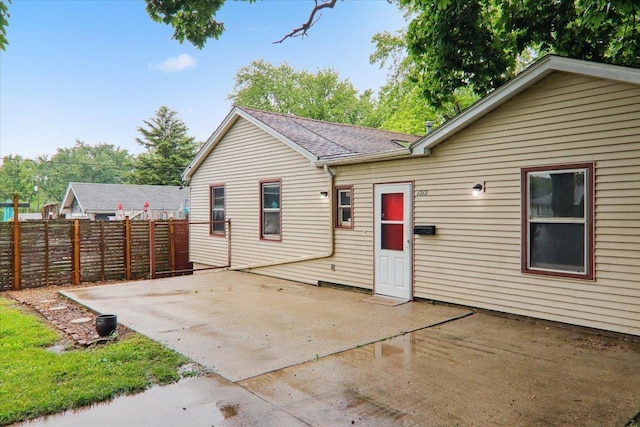 1212 Colton Ave, Bloomington, IL 61701 - back of house featuring a patio and a shingled roof