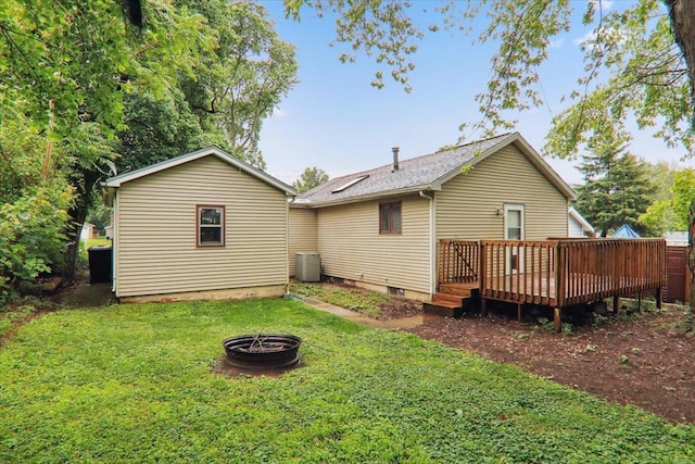1212 Colton Ave, Bloomington, IL 61701 - rear view of house featuring an outdoor fire pit, a wooden deck, a lawn, and cooling unit