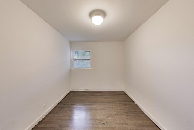 502 S William St, Mount Prospect, IL 60056 - spare room featuring dark wood-type flooring and baseboards