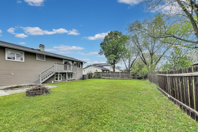 654 N Robinson Dr, Palatine, IL 60074 - view of yard with stairway, a deck, central AC unit, and an outdoor fire pit