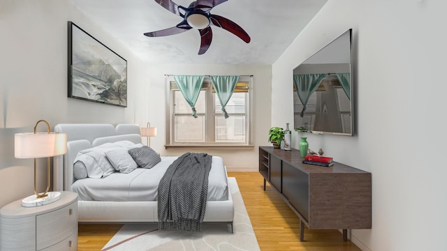 7360 N Damen Ave Unit 1S, Chicago, IL 60645 - bedroom featuring light wood-type flooring, a ceiling fan, and baseboards