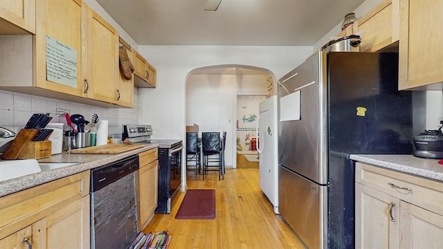 7360 N Damen Ave Unit 1S, Chicago, IL 60645 - kitchen with appliances with stainless steel finishes, light brown cabinets, arched walkways, and decorative backsplash