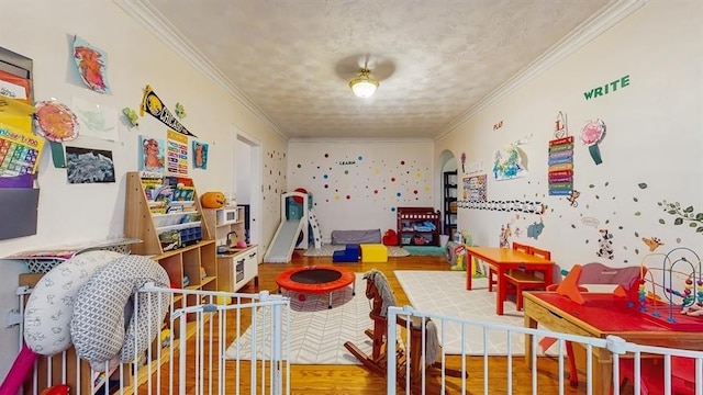 7360 N Damen Ave Unit 1S, Chicago, IL 60645 - game room featuring wood finished floors, crown molding, and arched walkways