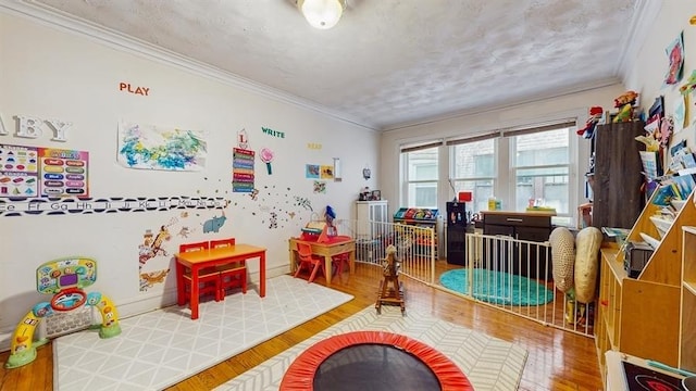 7360 N Damen Ave Unit 1S, Chicago, IL 60645 - recreation room with crown molding and wood finished floors