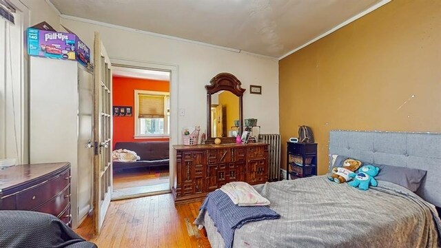 7360 N Damen Ave Unit 1S, Chicago, IL 60645 - bedroom featuring wood finished floors, ornamental molding, and french doors