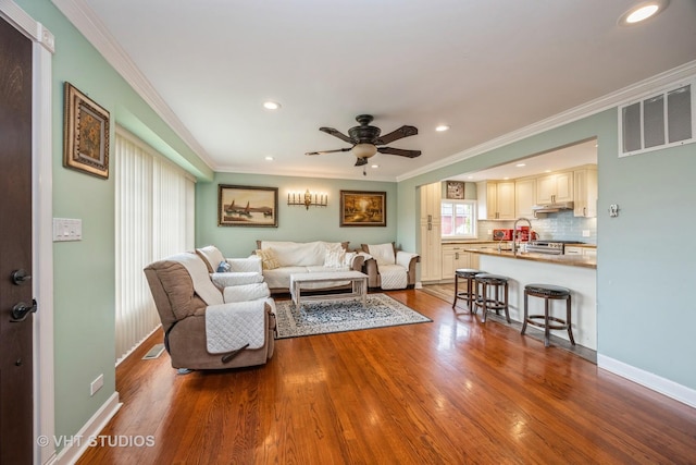 8349 W 82nd St, Justice, IL 60458 - living area featuring ornamental molding, wood finished floors, recessed lighting, a ceiling fan, and baseboards