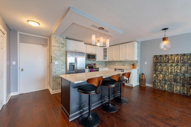5455 N Sheridan Rd Unit 3006, Chicago, IL 60640 - kitchen with stainless steel appliances, glass insert cabinets, light countertops, dark wood-style floors, and white cabinetry
