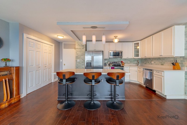 5455 N Sheridan Rd Unit 3006, Chicago, IL 60640 - kitchen featuring stainless steel appliances, a kitchen bar, white cabinets, and dark wood finished floors