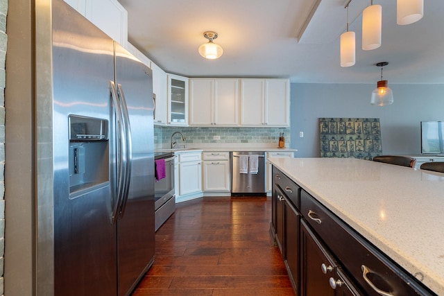 5455 N Sheridan Rd Unit 3006, Chicago, IL 60640 - kitchen with appliances with stainless steel finishes, dark wood-style floors, tasteful backsplash, decorative light fixtures, and white cabinetry