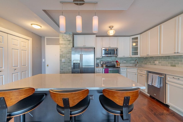 5455 N Sheridan Rd Unit 3006, Chicago, IL 60640 - kitchen with appliances with stainless steel finishes, a breakfast bar area, decorative backsplash, and white cabinets