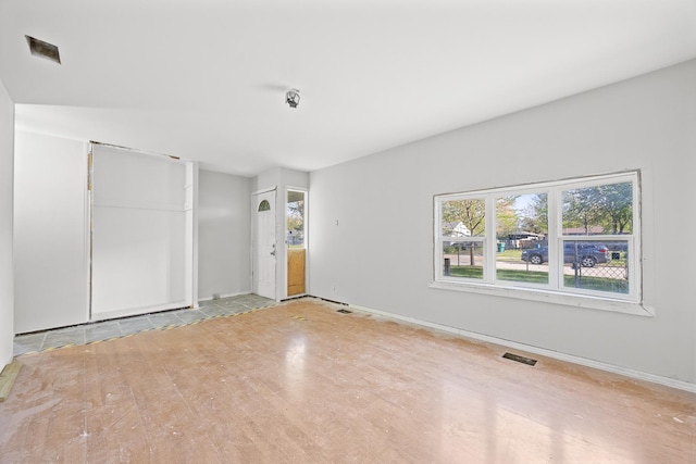 1315 Loral Ave, Joliet, IL 60435 - unfurnished bedroom with multiple windows, wood finished floors, and baseboards