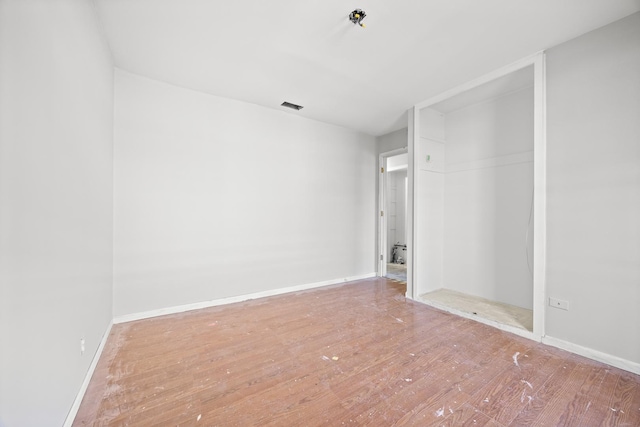 1315 Loral Ave, Joliet, IL 60435 - spare room with wood finished floors, baseboards, and a pendent fire sprinkler